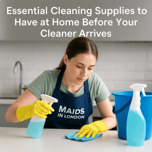 Essential Cleaning Supplies to Have at Home Before Your Cleaner Arrives 2 Professional cleaner in Maids in London apron using spray and cloth – essential cleaning supplies before cleaner arrives
